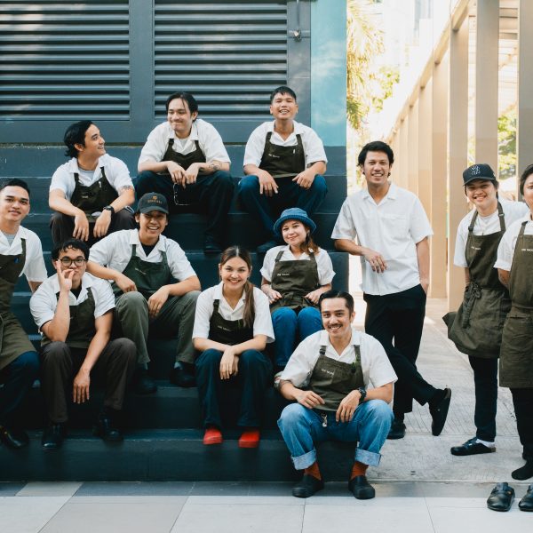 Los Tacos MNL kitchen team plating dishes together